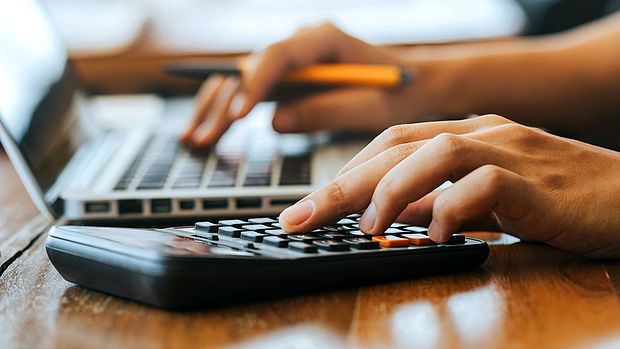 Hands typing on laptop