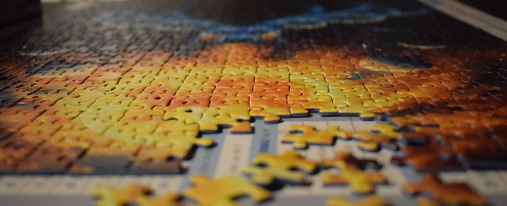 Incomplete jigsaw puzzle with missing pieces in foreground