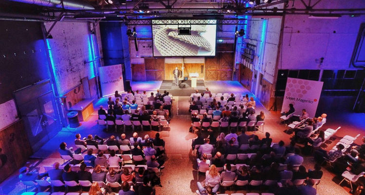 Audience and stage during a MaxServ event